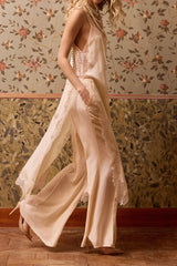 Side view of the nude Balma slip, deep side slit open over wide trousers
