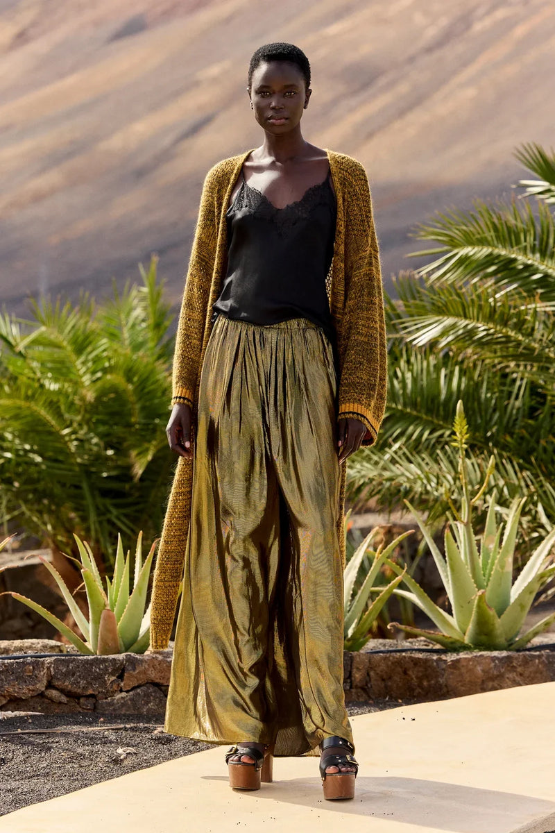 Leone lurex trousers in charcoal and gold worn with a black camisole and a long knit cardigan