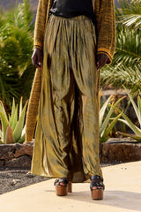 Leone wide-leg trousers catching the light, gathered at the elasticated waist