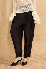 Mes Demoiselles Niko Pants in black, worn with an ivory open-knit sweater and pointed heels, waist-down front view
