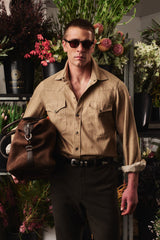 Chocolate Weekender carried with a sand overshirt and sunglasses