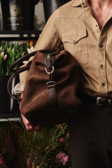 Close view of the chocolate Weekender carried at the hip