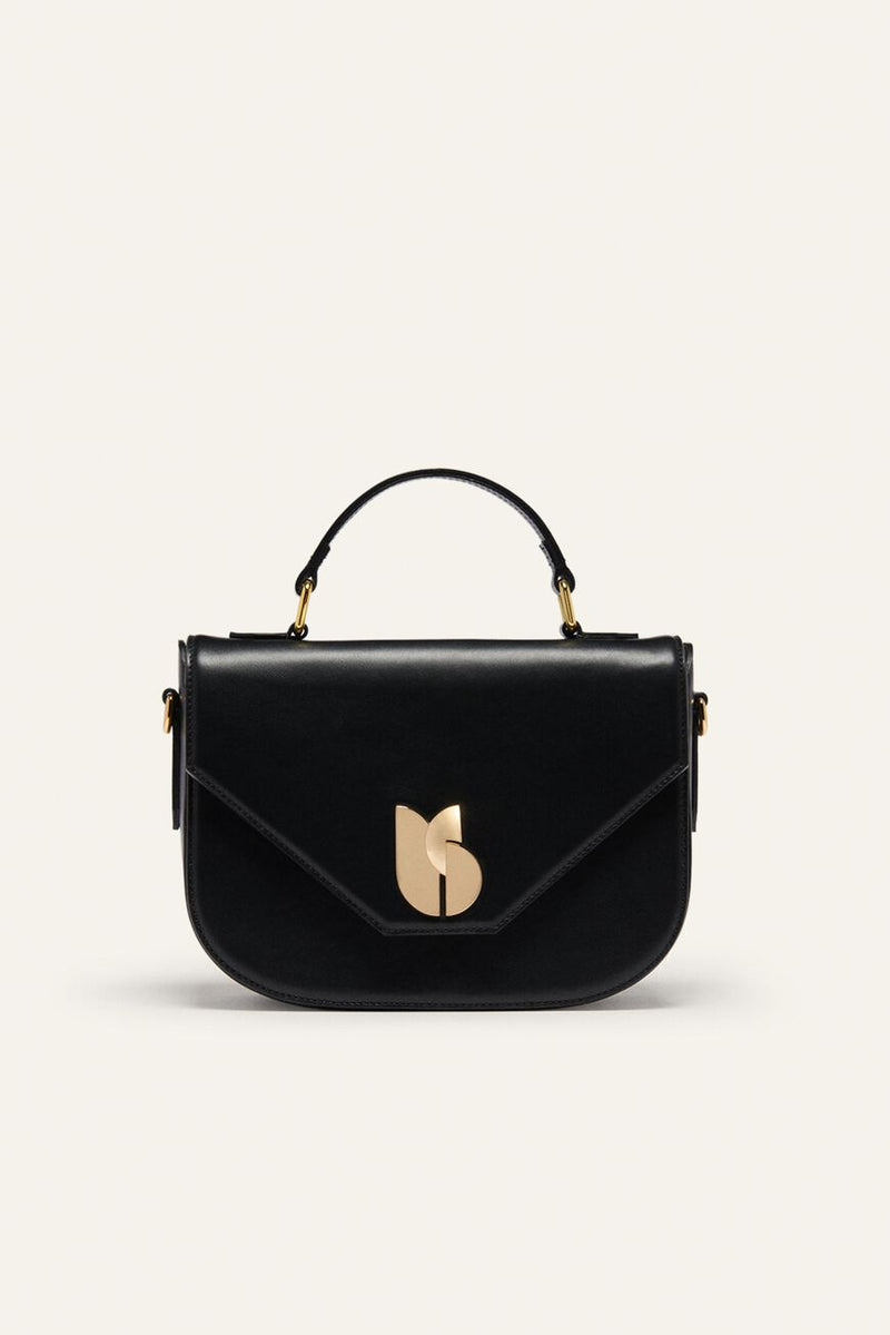 Black leather Sign bag with a half-moon flap, gold monogram clasp and top handle, studio view