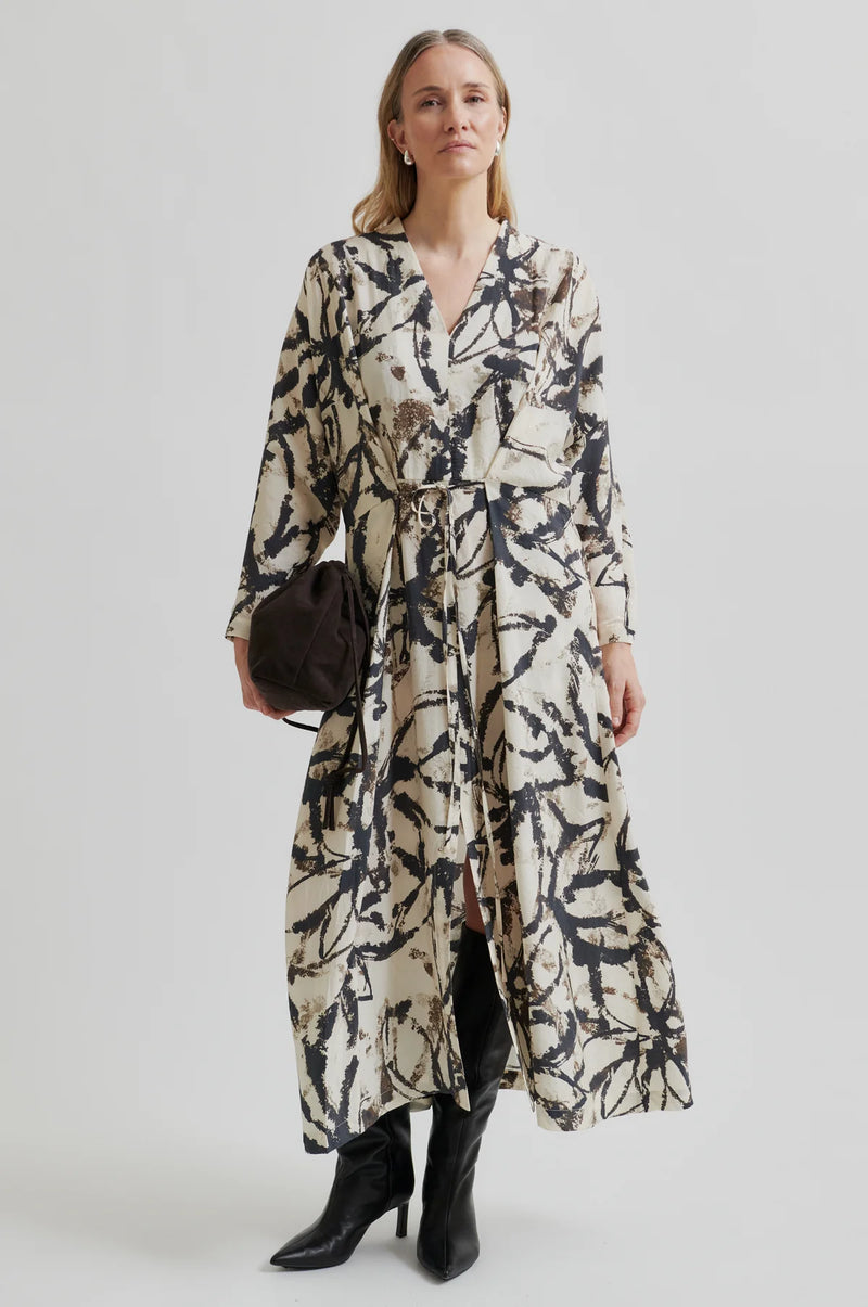 Second Female Cornelis Dress in tofu with black leaf print, worn by model, front view
