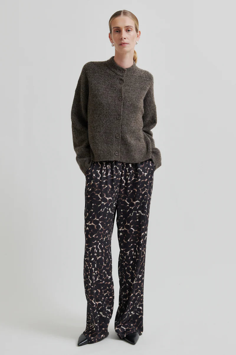 Second Female Savani Trousers in dark animal print, worn by model with a brown knit