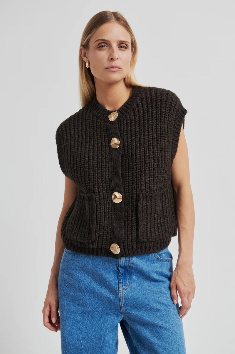 Second Female Urikke Brooch Knit Vest in chocolate torte, gold buttons, worn by model, front view