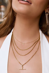 Arms of Eve Mini Initial Stone Necklace in gold, worn by model, styled view