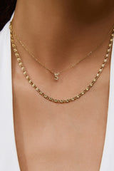 Arms of Eve Mini Initial Stone Necklace in gold, worn by model, close view