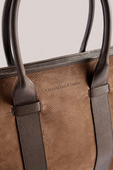 Close view of the leather handles and stamped logo on the chocolate Business Tote