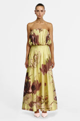 Yellow maxi skirt painted with brown and pink brushstroke florals, worn with the matching strapless top, front view