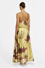 Back view of the A-line maxi skirt falling to the ankle, worn with pale pink heels