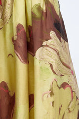 Close view of the brown, cream and pink brushstroke floral on yellow linen, with soft pleats
