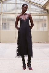 Black Balma slip with lace at the neckline and side panels, hands at the sides