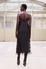 Back view of the black Balma slip dress worn with red heels