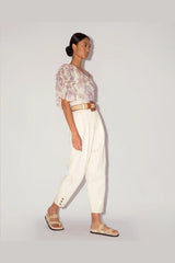 Magali Pascal Desa Top in jasmine light floral, worn by model with cream trousers, side view