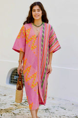Devotion Twins Roubini Midi Dress in pink and orange, worn by model outdoors, front view