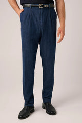Washed indigo denim chinos with a single front pleat, worn with a woven leather belt and black loafers