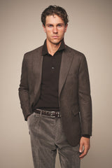 Vintage brown corduroy trousers worn with a brown jacket and dark polo