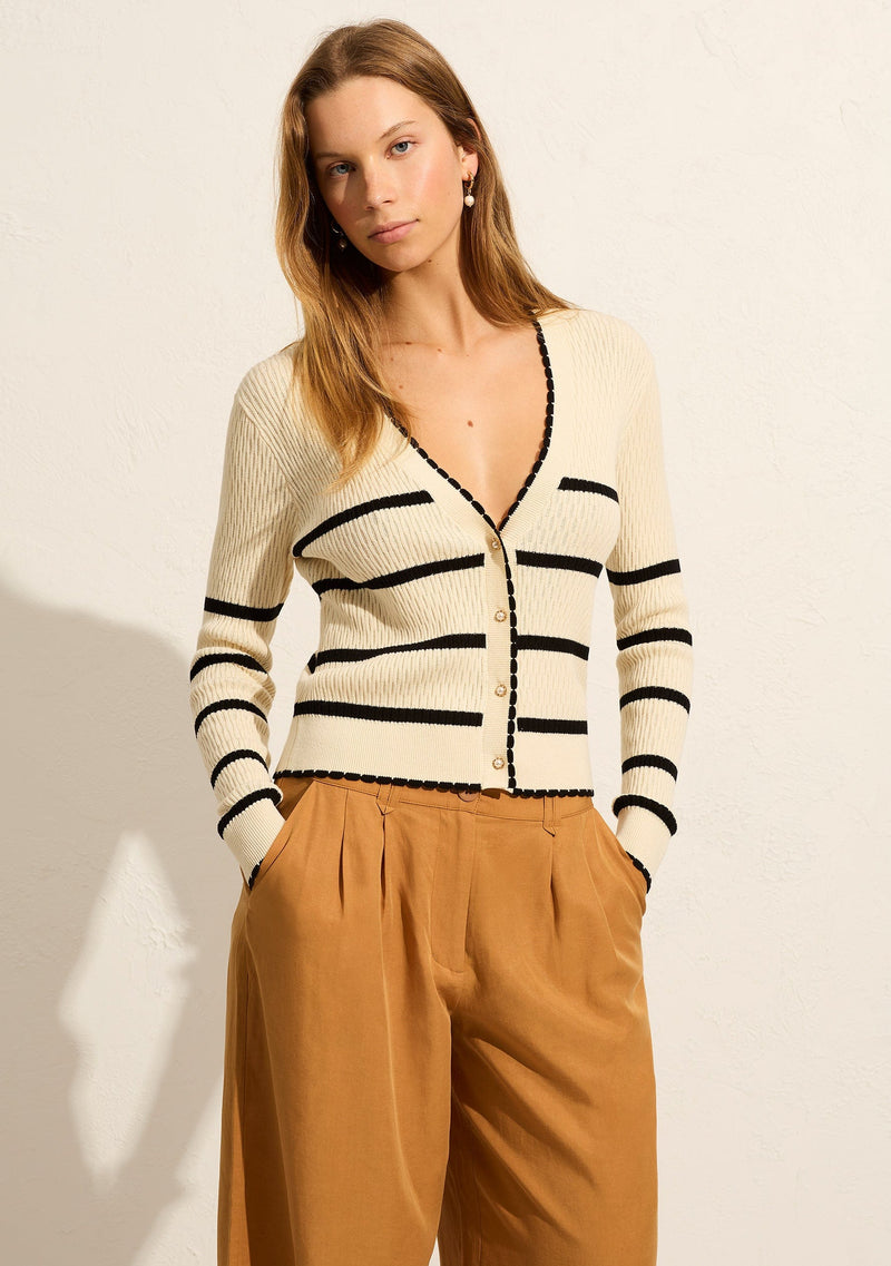 Auguste, Tommy Cardigan