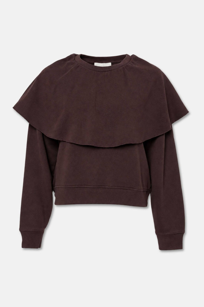 Brown cotton sweatshirt with a pleated cape layer across the shoulders, laid flat on a pale grey background