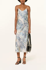 Blue and ecru animal print midi slip dress with wedge sandals and a black shoulder bag, full length front view