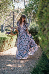 Mes Demoiselles Orma dress in lavender tie-dye, worn with a basket of fresh lavender on a garden path at Polperro