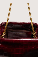 Inside the bag, open at the centre hinge, showing the cotton lining and a leather slip pocket stamped Viktoria & Woods