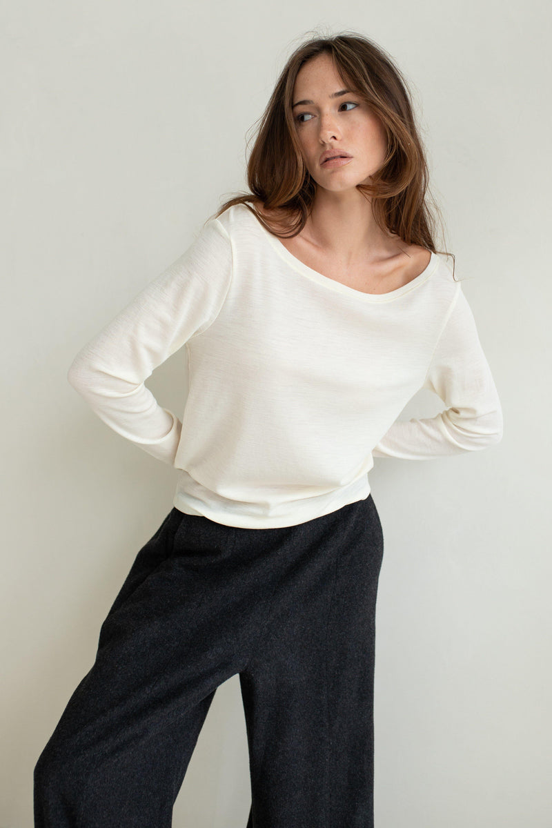 Vaenn Baby Wool Long Sleeve Wide Neck Crew in double cream, worn by model with charcoal trousers, front view