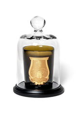 Trudon La Cloche, clear glass bell jar on a black base covering a green glass candle