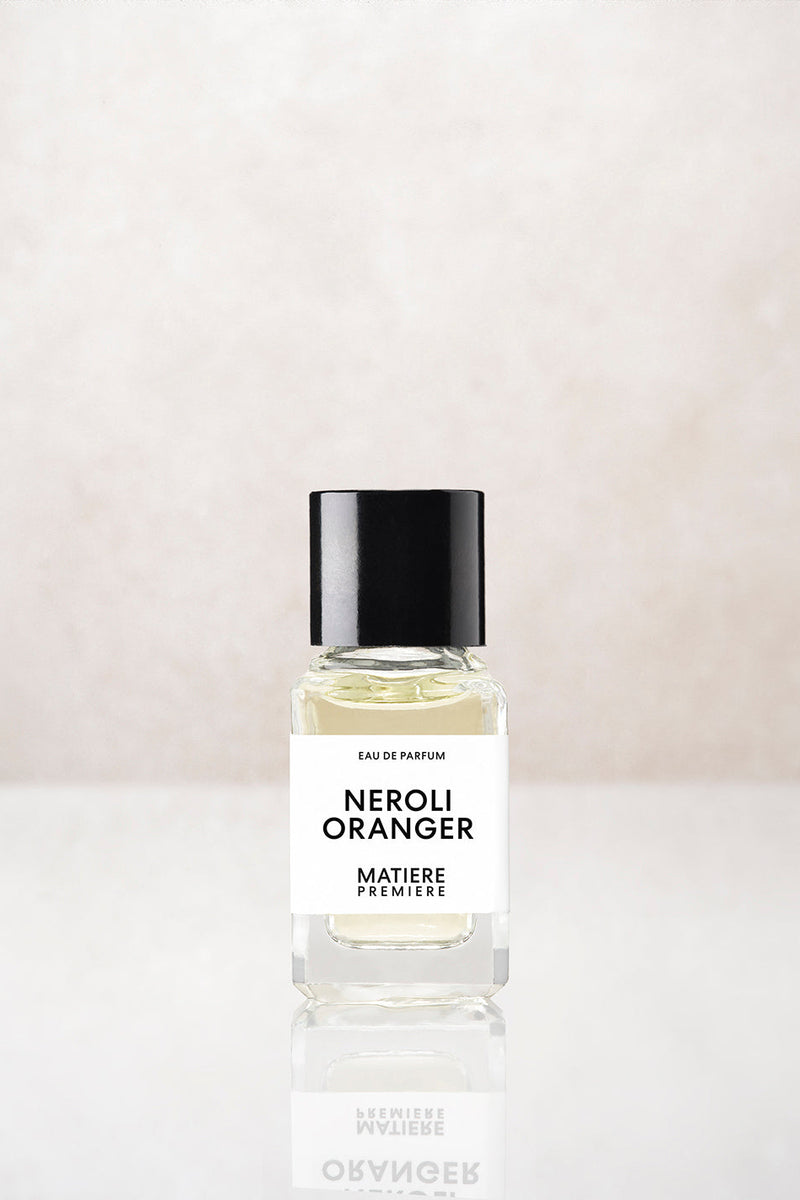 Matière Première Neroli Oranger 6ml eau de parfum, small glass bottle with black cap on pale stone