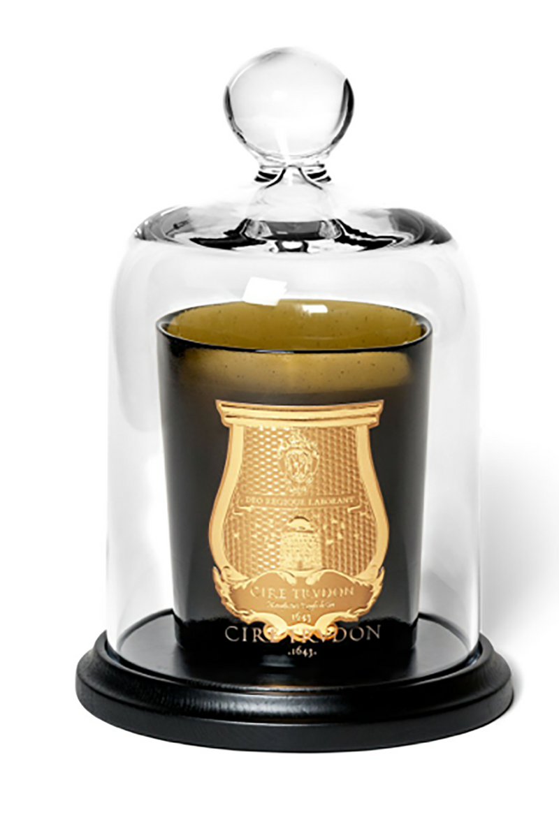 Trudon Petite Cloche, clear glass bell jar on black base covering a green glass candle